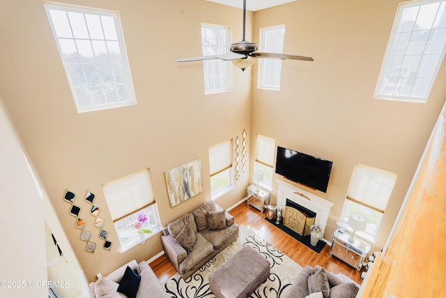 19 Summerhill Ave, Jackson, NJ 08527 - living area featuring a fireplace with flush hearth, a high ceiling, and wood finished floors