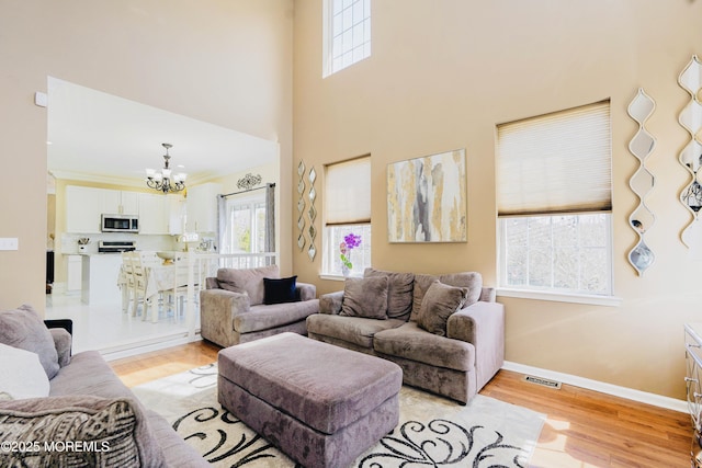 19 Summerhill Ave, Jackson, NJ 08527 - living area with light wood-style floors, a healthy amount of sunlight, an inviting chandelier, and visible vents