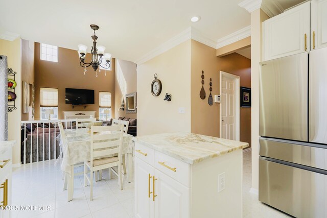 19 Summerhill Ave, Jackson, NJ 08527 - kitchen featuring freestanding refrigerator, light tile patterned floors, light stone countertops, ornamental molding, and open floor plan