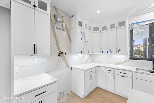 18 Seaview Ave, Long Branch, NJ 07740 - kitchen featuring light stone countertops, white cabinets, glass insert cabinets, and recessed lighting