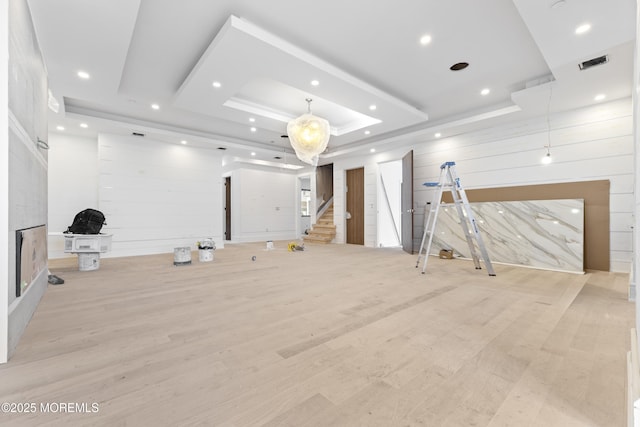 18 Seaview Ave, Long Branch, NJ 07740 - exercise area with a raised ceiling, light wood-style floors, recessed lighting, wooden walls, and a fireplace