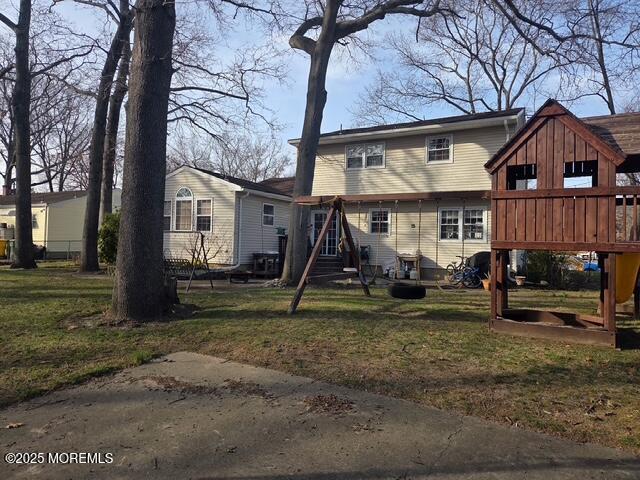rear view of house with a yard