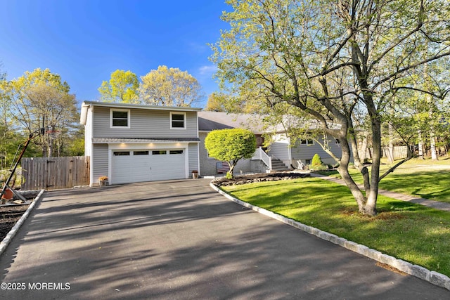 113 Parker Rd, West Long Branch, NJ 07764 - tri-level home with a front yard, aphalt driveway, a garage, and fence
