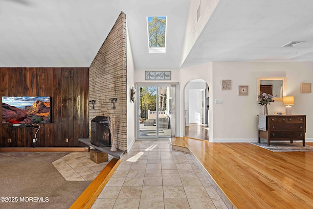 113 Parker Rd, West Long Branch, NJ 07764 - foyer with baseboards, visible vents, a towering ceiling, arched walkways, and a fireplace
