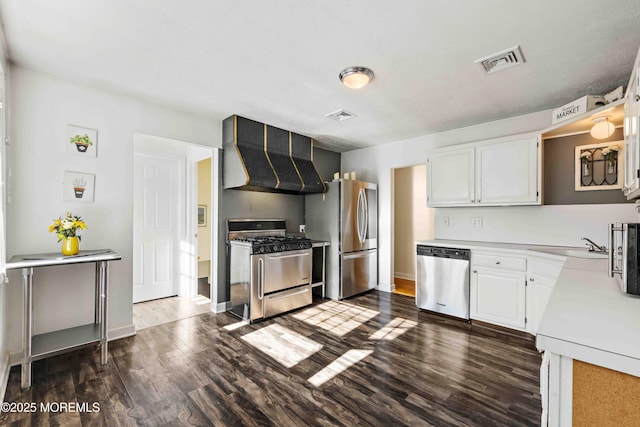 113 Parker Rd, West Long Branch, NJ 07764 - kitchen with light countertops, stainless steel appliances, visible vents, and dark wood-style floors