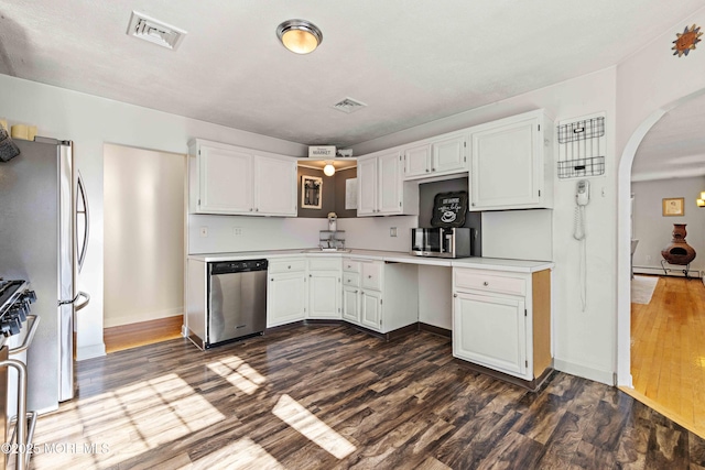 113 Parker Rd, West Long Branch, NJ 07764 - kitchen featuring stainless steel appliances, visible vents, arched walkways, and dark wood-type flooring