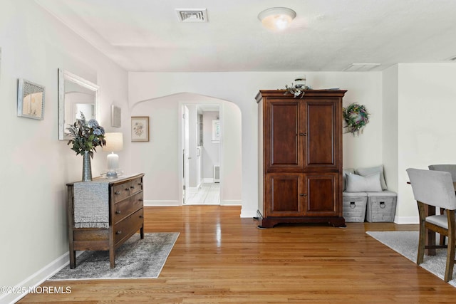 113 Parker Rd, West Long Branch, NJ 07764 - sitting room featuring light wood finished floors, visible vents, baseboards, and arched walkways