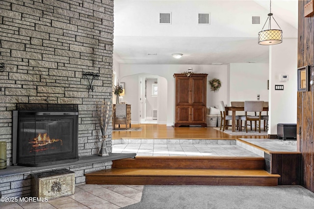 113 Parker Rd, West Long Branch, NJ 07764 - stairway featuring tile patterned flooring, visible vents, a fireplace, and arched walkways