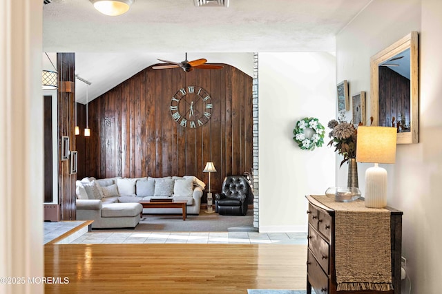 113 Parker Rd, West Long Branch, NJ 07764 - tiled living area with wood walls, visible vents, vaulted ceiling, ceiling fan, and baseboards