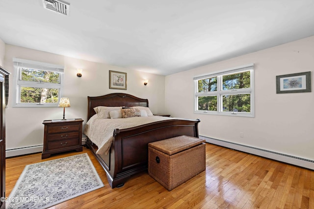 113 Parker Rd, West Long Branch, NJ 07764 - bedroom with light wood-style floors, a baseboard radiator, visible vents, and a baseboard heating unit