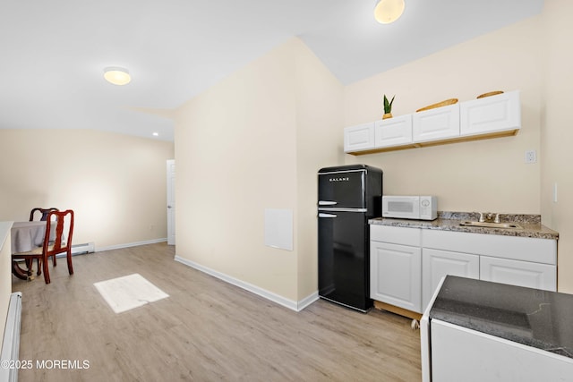 113 Parker Rd, West Long Branch, NJ 07764 - kitchen featuring freestanding refrigerator, white microwave, white cabinets, and light wood-type flooring