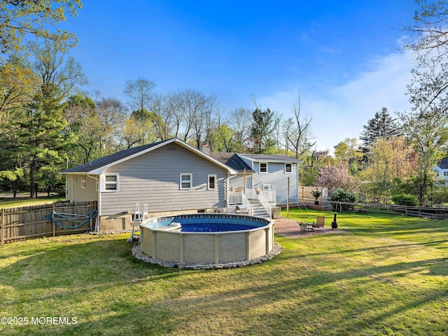 113 Parker Rd, West Long Branch, NJ 07764 - back of house with a fenced backyard, a deck, a fenced in pool, and a yard