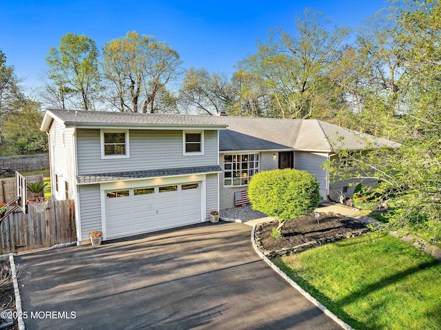 113 Parker Rd, West Long Branch, NJ 07764 - split level home featuring aphalt driveway, fence, a garage, and roof with shingles
