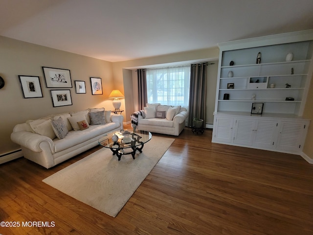 living area with baseboard heating and wood finished floors