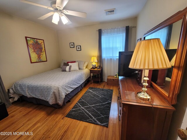 bedroom with visible vents and wood finished floors