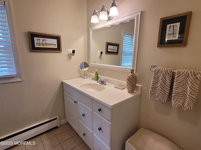 bathroom with tile patterned flooring, plenty of natural light, baseboard heating, and vanity