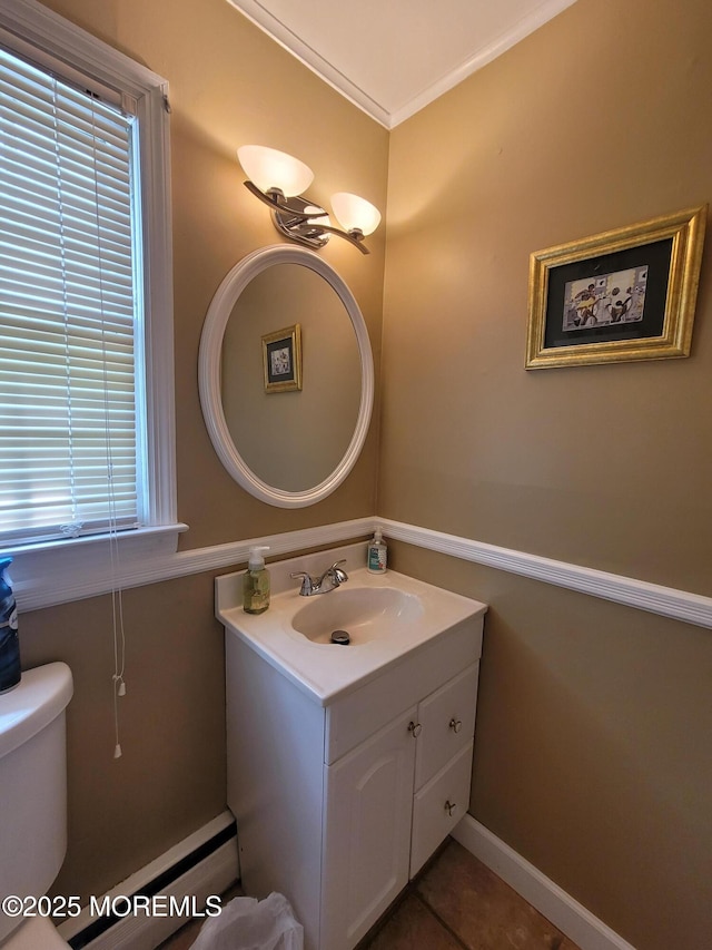 half bathroom featuring vanity, tile patterned flooring, ornamental molding, and toilet