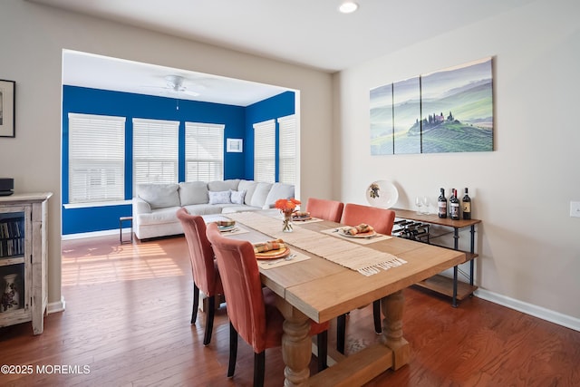 dining area with baseboards, wood finished floors, and a ceiling fan