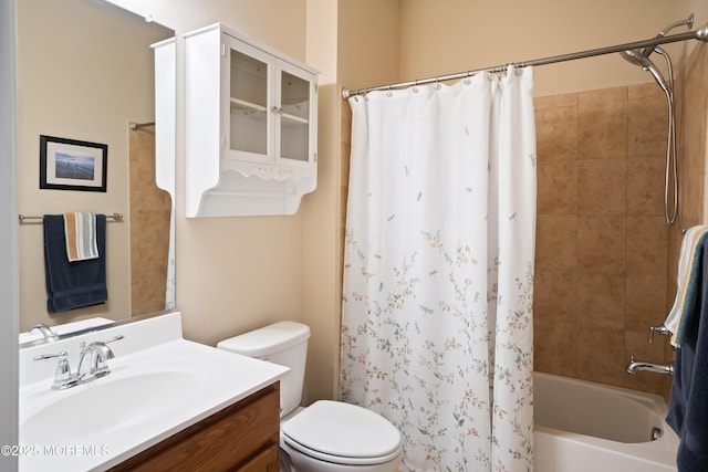 bathroom featuring toilet, shower / tub combo, and vanity