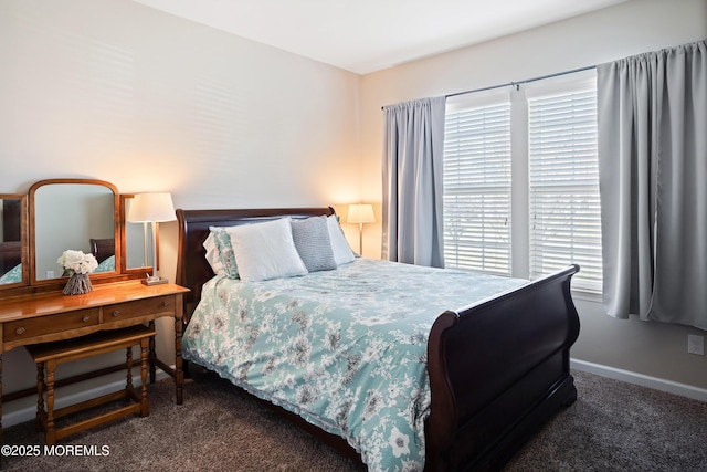 carpeted bedroom featuring baseboards and multiple windows