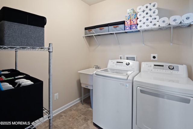 clothes washing area featuring laundry area, baseboards, and separate washer and dryer