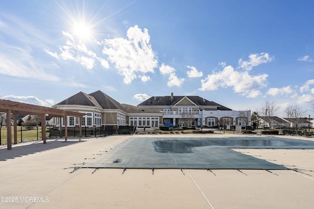 pool featuring a patio area, fence, and a pergola