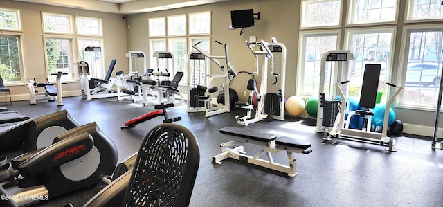 workout area with a high ceiling and baseboards