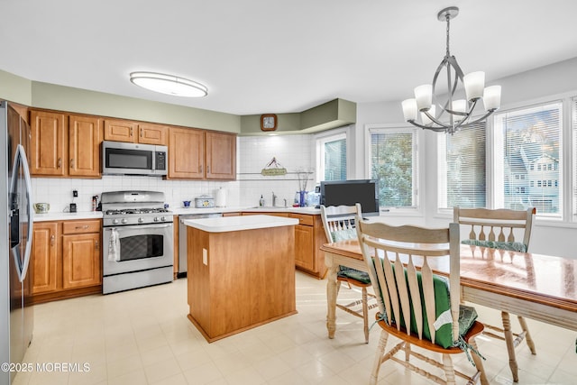 265 Marigold Ct, Toms River, NJ 08757 - kitchen with a sink, light countertops, appliances with stainless steel finishes, and a chandelier