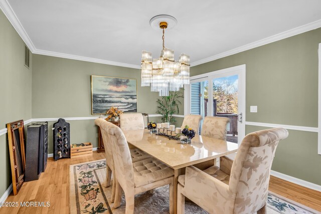 265 Marigold Ct, Toms River, NJ 08757 - dining area with wood finished floors, an inviting chandelier, and crown molding
