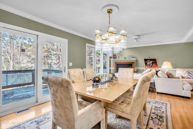 265 Marigold Ct, Toms River, NJ 08757 - dining room featuring light wood-type flooring, crown molding, and visible vents