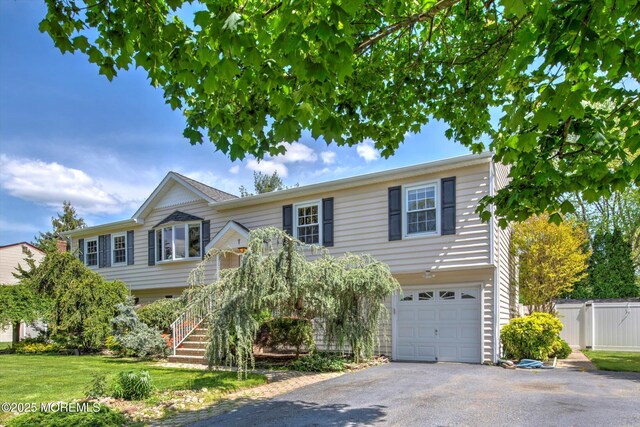 7 Mill Rd, Jamesburg, NJ 08831 - view of front of property featuring fence, driveway, and an attached garage