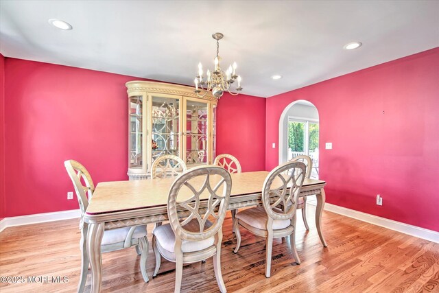 7 Mill Rd, Jamesburg, NJ 08831 - dining area with baseboards, arched walkways, a notable chandelier, and light wood finished floors