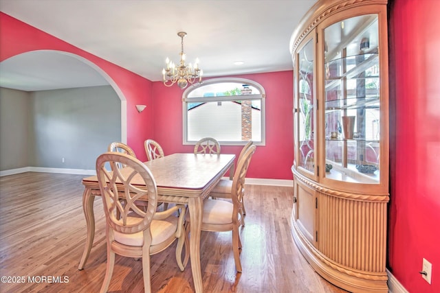 7 Mill Rd, Jamesburg, NJ 08831 - dining room with a chandelier, baseboards, arched walkways, and light wood-type flooring