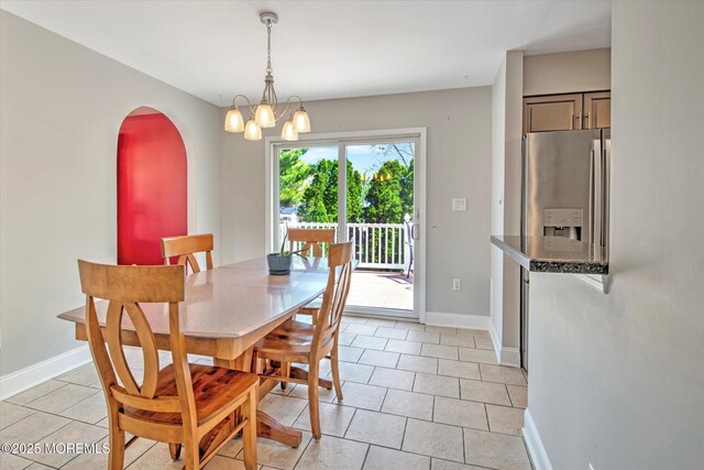 7 Mill Rd, Jamesburg, NJ 08831 - dining area with baseboards, light tile patterned floors, arched walkways, and a chandelier