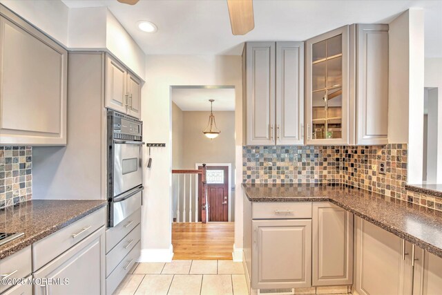 7 Mill Rd, Jamesburg, NJ 08831 - kitchen with decorative backsplash, light tile patterned floors, glass insert cabinets, a warming drawer, and stainless steel oven