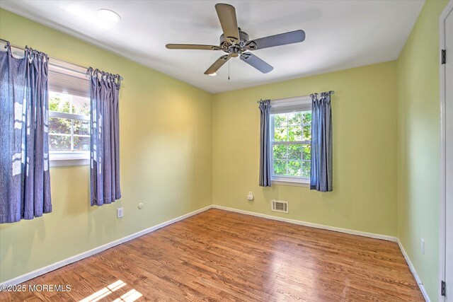 7 Mill Rd, Jamesburg, NJ 08831 - empty room featuring visible vents, ceiling fan, wood finished floors, and baseboards
