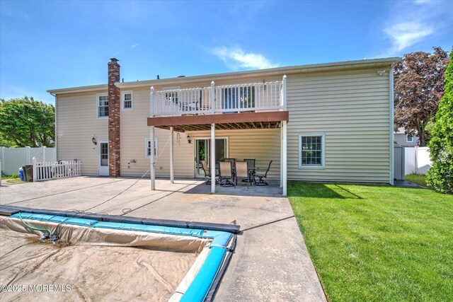 7 Mill Rd, Jamesburg, NJ 08831 - rear view of property featuring fence, a patio area, and a lawn