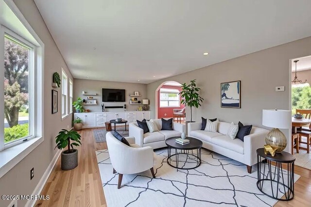7 Mill Rd, Jamesburg, NJ 08831 - living area with wood finished floors, a wealth of natural light, and arched walkways