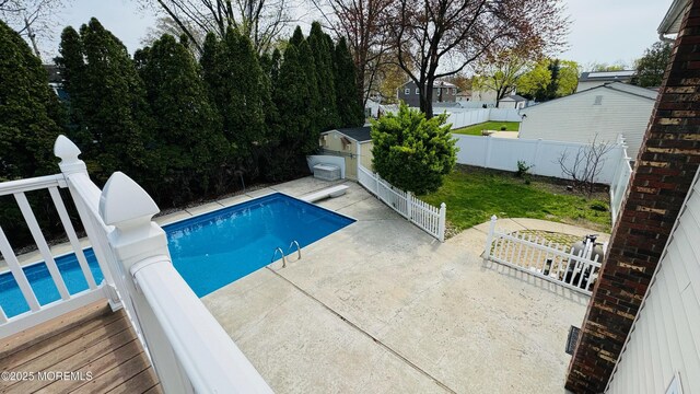 7 Mill Rd, Jamesburg, NJ 08831 - view of swimming pool featuring a fenced backyard, a storage unit, an outbuilding, a fenced in pool, and a patio area