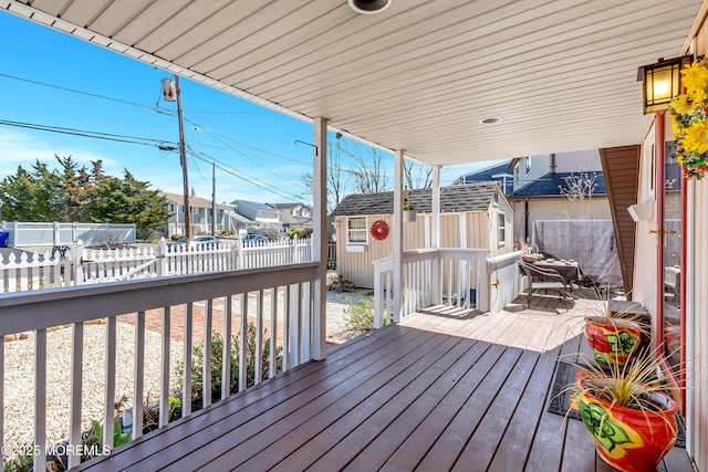 148 Royal Dr, Brick, NJ 08723 - wooden terrace featuring a fenced backyard, an outbuilding, a storage unit, and a residential view