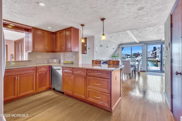 148 Royal Dr, Brick, NJ 08723 - kitchen with brown cabinets, light wood-type flooring, a sink, and a peninsula