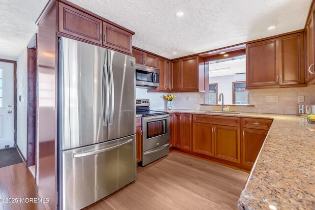 148 Royal Dr, Brick, NJ 08723 - kitchen with a sink, appliances with stainless steel finishes, brown cabinets, and light wood-type flooring