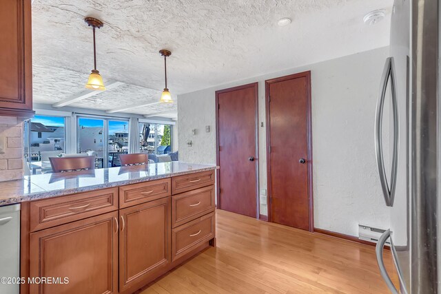 148 Royal Dr, Brick, NJ 08723 - kitchen with a textured ceiling, light wood-type flooring, pendant lighting, brown cabinetry, and freestanding refrigerator