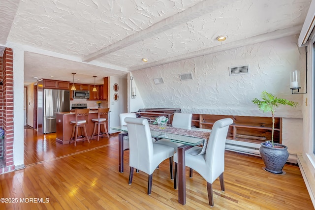 148 Royal Dr, Brick, NJ 08723 - dining area featuring beamed ceiling, visible vents, light wood-type flooring, and a textured wall
