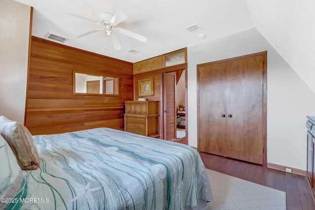 148 Royal Dr, Brick, NJ 08723 - bedroom featuring visible vents, ceiling fan, wood walls, and hardwood / wood-style floors