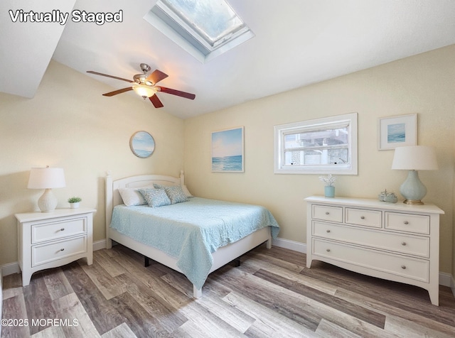 3 W Potomac Dr, Little Egg Harbor, NJ 08087 - bedroom featuring wood finished floors, a skylight, ceiling fan, and vaulted ceiling