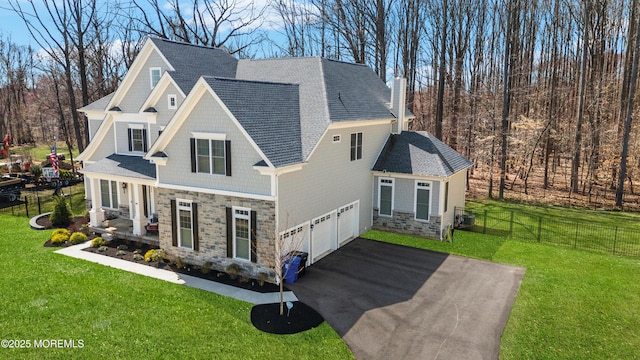 61 Windermere Rd, Lincroft, NJ 07738 - exterior space with a front yard, stone siding, a chimney, fence, and aphalt driveway