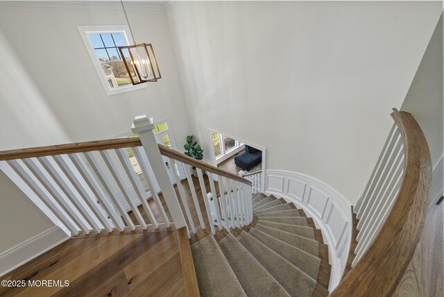 61 Windermere Rd, Lincroft, NJ 07738 - stairs featuring a decorative wall, a high ceiling, an inviting chandelier, and wainscoting