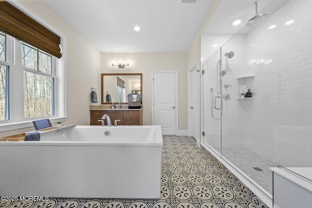 61 Windermere Rd, Lincroft, NJ 07738 - bathroom featuring a freestanding tub, a sink, a stall shower, and recessed lighting