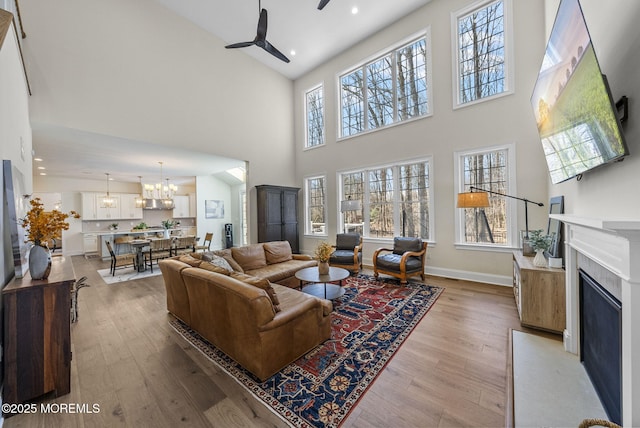 61 Windermere Rd, Lincroft, NJ 07738 - living area with recessed lighting, ceiling fan with notable chandelier, a fireplace with flush hearth, baseboards, and light wood-style flooring